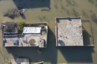 An aerial view of the al-Tlul village flooded after a devastating earthquake destroyed a river dam in the town of Salqeen near the Turkish border, Idlib province, Syria, Thursday, Feb. 9, 2023. (AP Photo/Ghaith Alsayed)