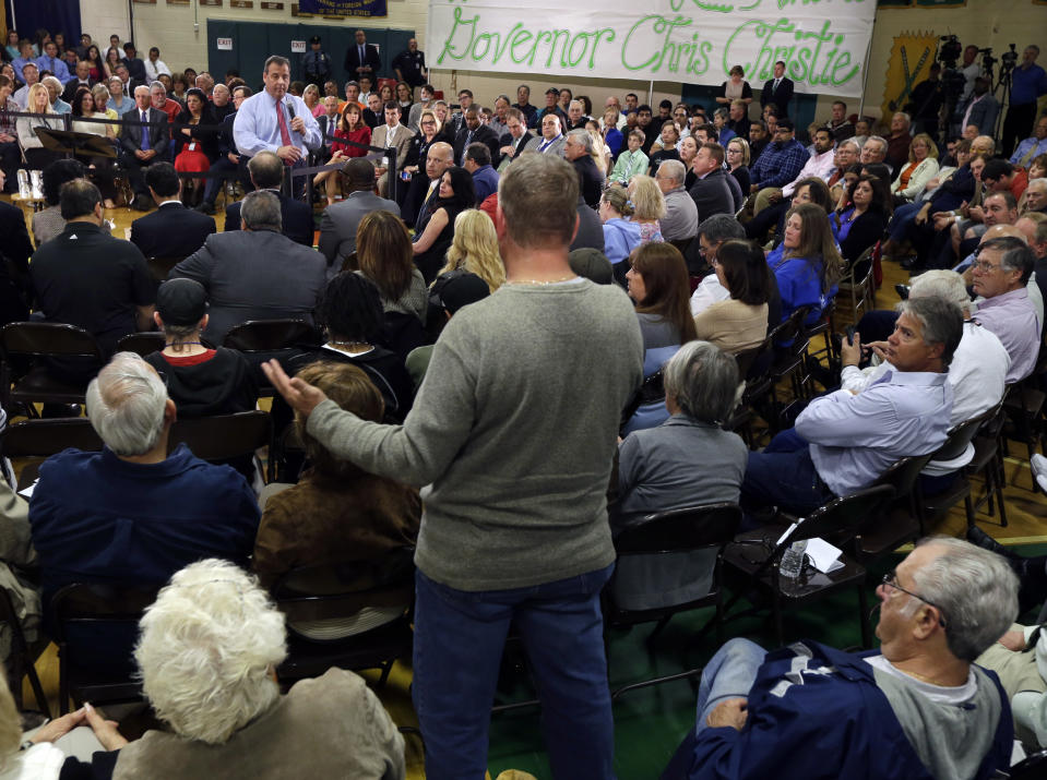 New Jersey Gov. Chris Christie, back center left, listens to a question during a town hall meeting in Brick Township, N.J., Thursday, April 24, 2014. Many questions at the town hall focused on the state's Sandy recovery efforts. (AP Photo/Mel Evans)