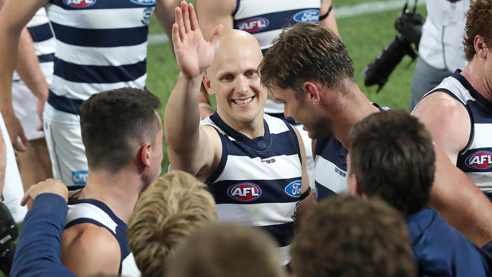 Geelong's Gary Ablett Jr is pictured celebrating with teammates after winning the AFL preliminary final against Brisbane.