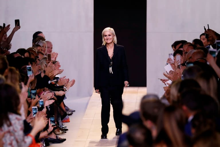 Fashion designer for Christian Dior, Maria Grazia Chiuri (C) acknowledges the audience at the end of the show