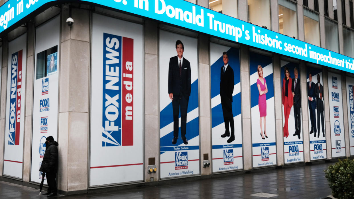 Heeadlines on former President Donald Trump's second impeachment trial are displayed at the New York headquarters of Fox in February.