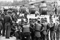 United States Marines Helicopter Squadron huddled at Da Nang in 1963 for the final briefing on a March 31, 1965, mission: to airlift a battalion of Vietnamese infantry to an isolated area about 20 miles away. (Larry Burrows—Time & Life Pictures/Getty Images) <br> <br> <a href="http://life.time.com/history/vietnam-war-one-ride-with-yankee-papa-13/#1" rel="nofollow noopener" target="_blank" data-ylk="slk:Click here to see the full collection at LIFE.com;elm:context_link;itc:0;sec:content-canvas" class="link ">Click here to see the full collection at LIFE.com</a>