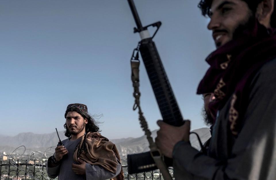 Taliban security personnel stand guard at the Wazir Akbar Khan hilltop overlooking Kabul city on 2 July (AFP via Getty Images)