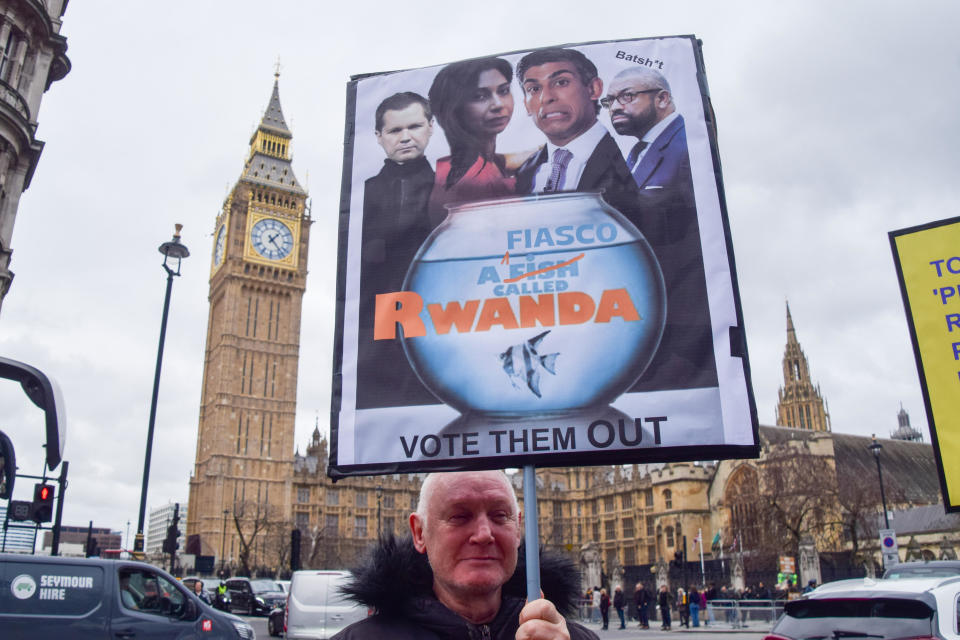 A protester holds a placard mocking the government's Rwanda plan for asylum seekers during a demonstration in Parliament Square, London, March 13, 2024. / Credit: Vuk Valcic/SOPA Images/LightRocket/Getty