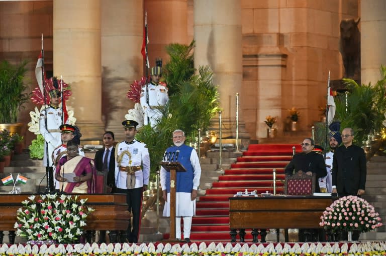 Indian Prime Minister Narendra Modi takes the oath of office at the presidential palace; later in the ceremony, a 'leopard-like' animal was seemingly spotted prowling past at the top of the steps (Money SHARMA)