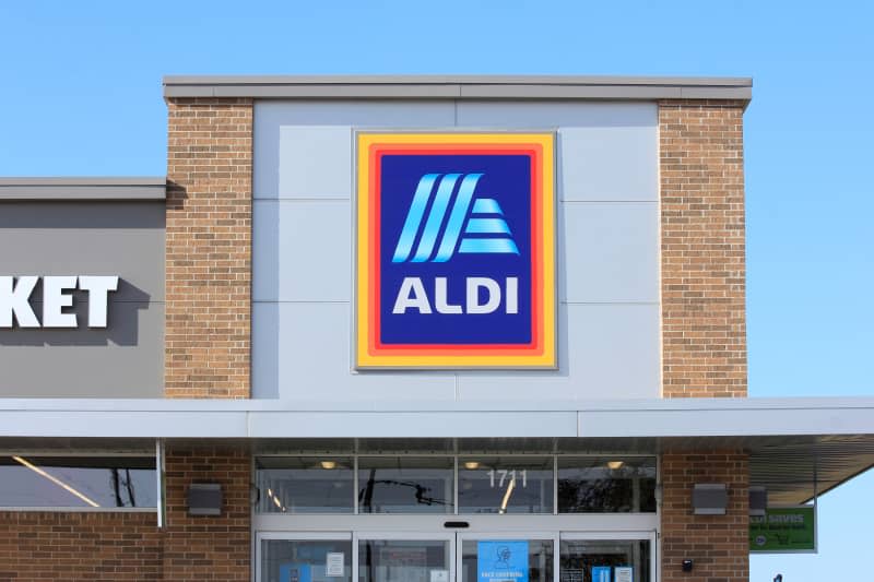 A shot of an Aldi food market sign that's bright and colorful with a blue sky in Hutchinson Kansas USA that was on 9-13-2020.