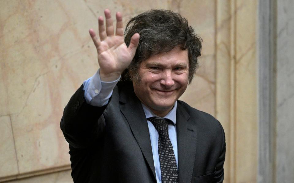 Argentina's President-elect Javier Milei waves during a session at the Argentine Congress in Buenos Aires on November 29