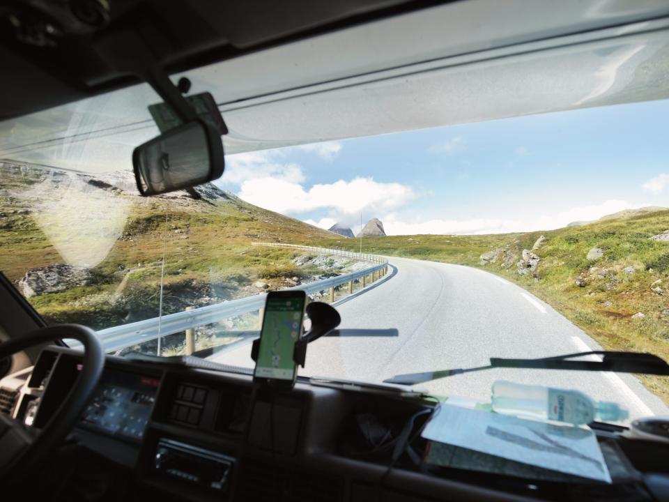 View from cabine of campervan crusing high mountains in Norway. Cloudy, blue skies.