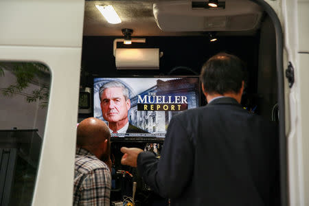 Media personnel are seen following the news ahead of the release of the Special Counsel Robert Mueller's report in Washington, U.S., April 18, 2019. REUTERS/Amr Alfiky