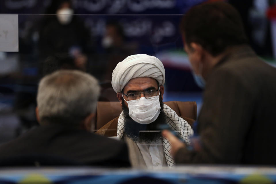 A clergyman registers his name as a candidate for the June 18, presidential elections at the interior Ministry in Tehran, Iran, Tuesday, May 11, 2021. Iran opened registration Tuesday for potential candidates in the country's June presidential election, kicking off the race as uncertainty looms over Tehran's tattered nuclear deal with world powers and tensions remain high with the West. (AP Photo/Vahid Salemi)