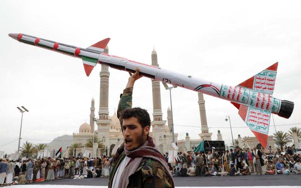 A Yemeni protester holds up a mock rocket at a pro-Palestine rally in Sanaa as Israel prepares its invasion of Rafah