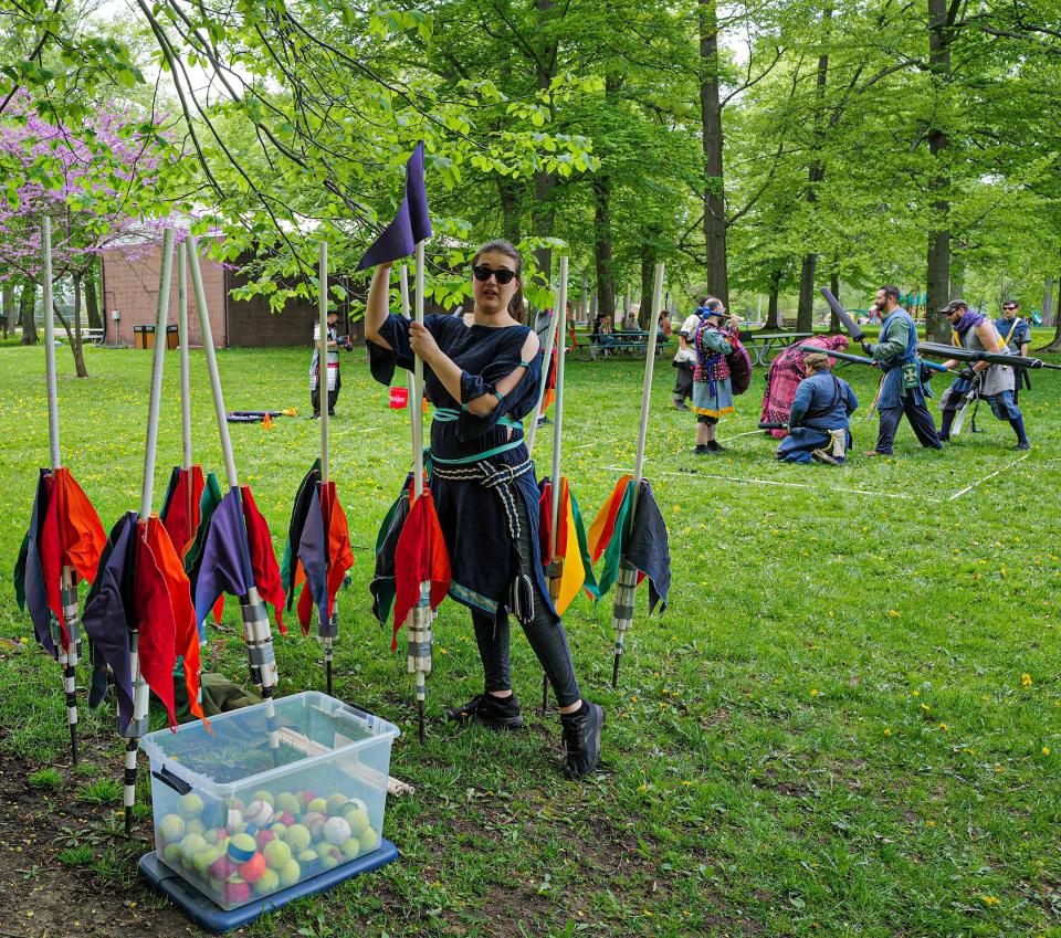 Lauren Warshaw, or Lady Alpaca, shows off equipment used for some of the role-playing games the community of Ashen Hills uses Sundays at Patriarche Park in East Lansing. The community encourages newcomers who want to participate in the sport and will loan equipment to use. Photo: Sunday, May 15, 2022.
