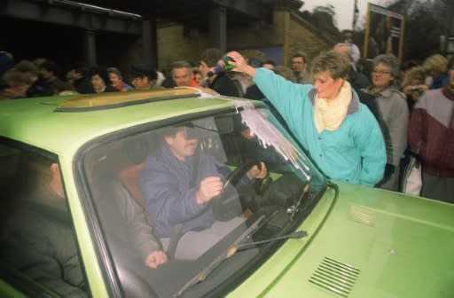 At one crossing, a West Berliner welcomed a compatriot from the East by pouring champagne over his car