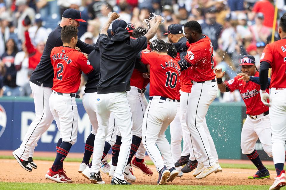 The Cleveland Guardians celebrate their 10th-inning win against the New York Yankees, April 14, 2024, in Cleveland.