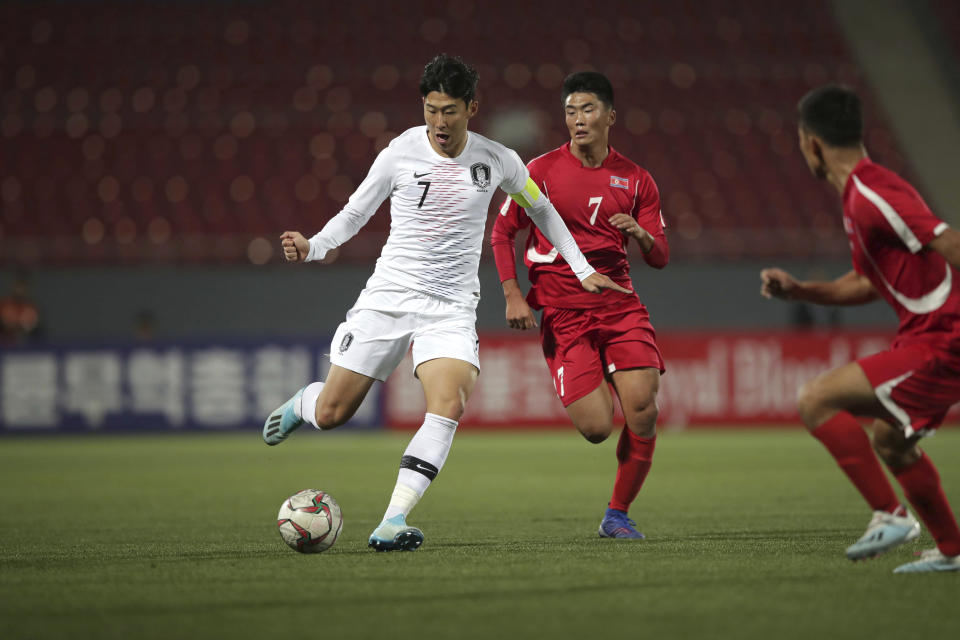 FILE - In this Oct. 15, 2019, file photo provided by the Korea Football Association, South Korea's Son Heung-min, left, fights for the ball against North Korea's Han Kwang Song during their Asian zone Group H qualifying soccer match for the 2022 World Cup at Kim Il Sung Stadium in Pyongyang, North Korea. The South Korean soccer association said Friday, Oct. 18, it has requested that North Korea be punished for blocking rival fans and media from attending a World Cup qualifier between the countries at an empty stadium in Pyongyang. (The Korea Football Association via AP, File)