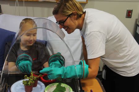 Science teacher Katie Stoudemire uses the WonderSphere with Harrison, a patient at the North Carolina Children’s Hospital in this undated handout photo. Photo courtesy of Alyssa LaFaro, UNC Research via REUTERS