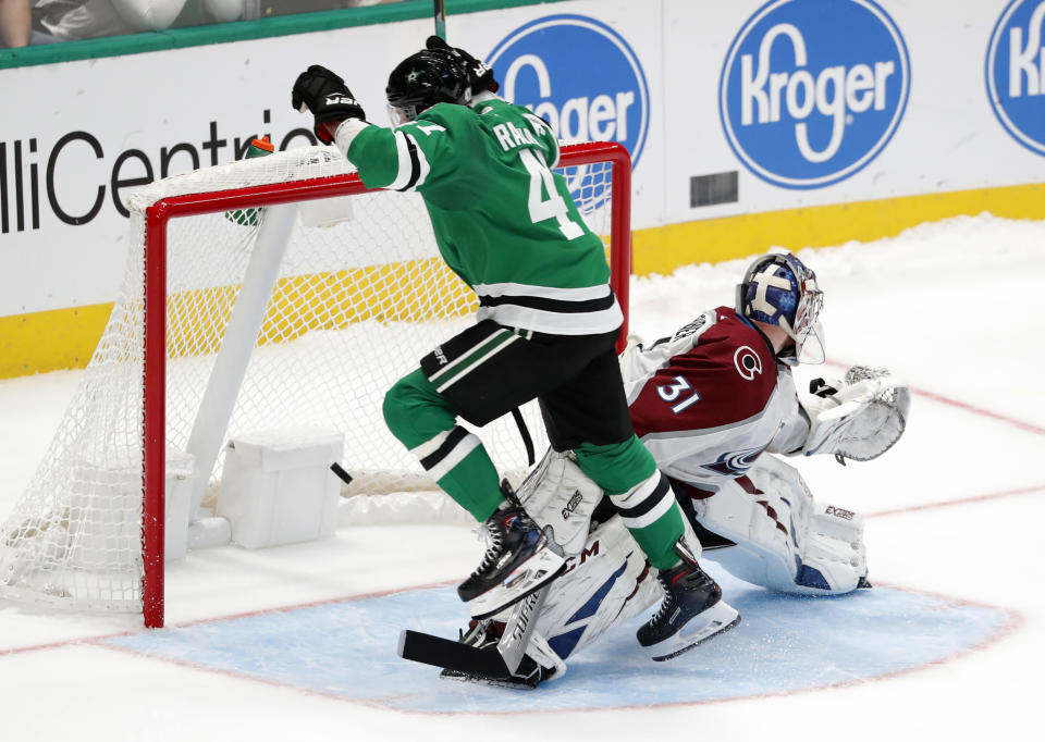 Dallas Stars right wing Alexander Radulov (47) leaps over Colorado Avalanche goaltender Philipp Grubauer (31) after scoring a shootout goal in overtime of a preseason NHL hockey game in Dallas, Saturday, Sept. 28, 2019. The Stars won 4-3. (AP Photo/Tony Gutierrez)