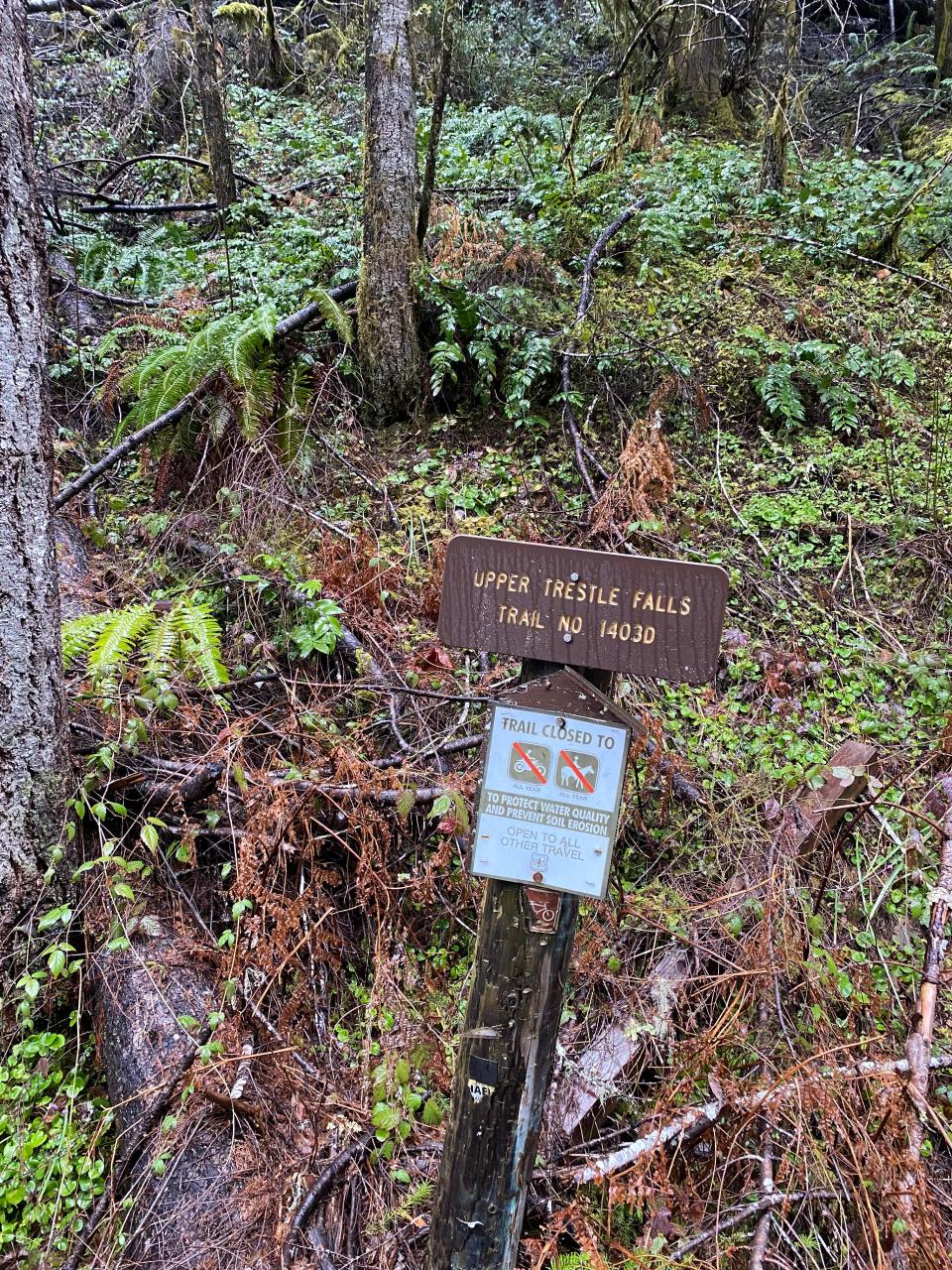 The sign for the Upper Trestle Creek Falls Trail along NF-22