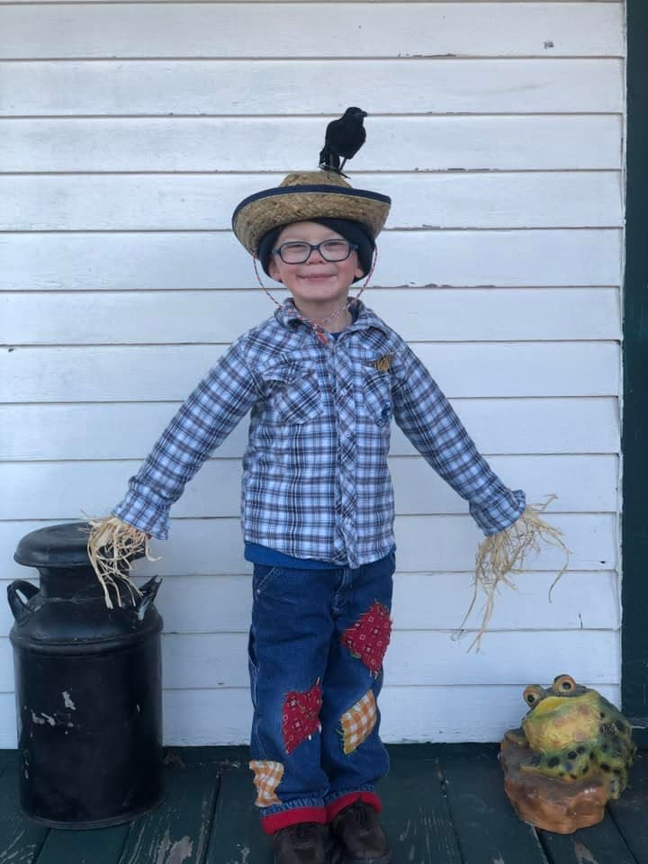 Henry Raether of New London proudly sports his homemade scarecrow costume. His mother, Sarah Raether, simply used clothes Henry already had, straw and raffia, and a fake crow she purchased on Amazon.