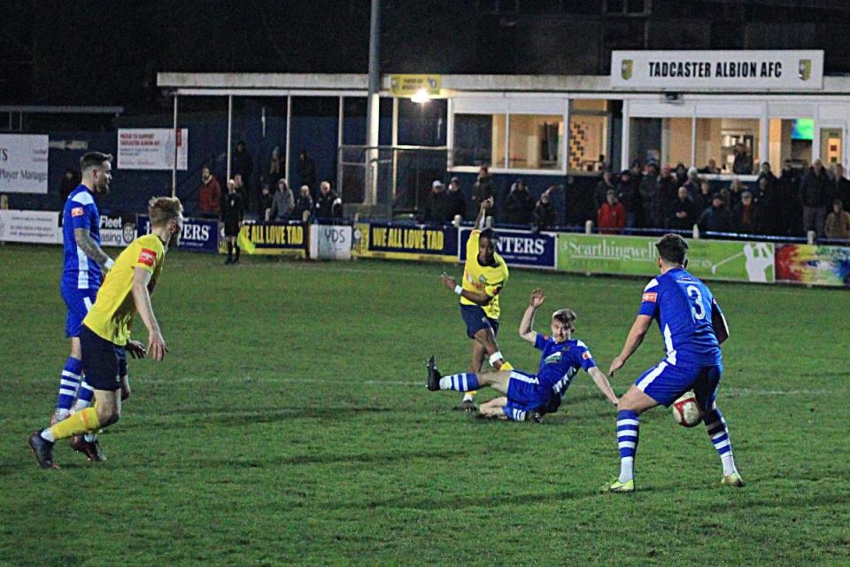 Sanyang (yellow) proved to be the hero for Tadcaster last night. <i>(Image: Keith Handley)</i>