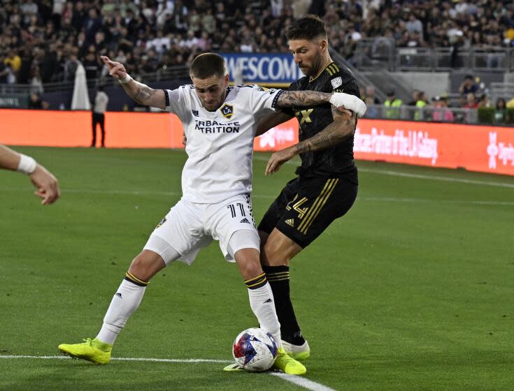 Galaxy midfielder Tyler Boyd vies for the ball with LAFC midfielder Ryan Hollingshead