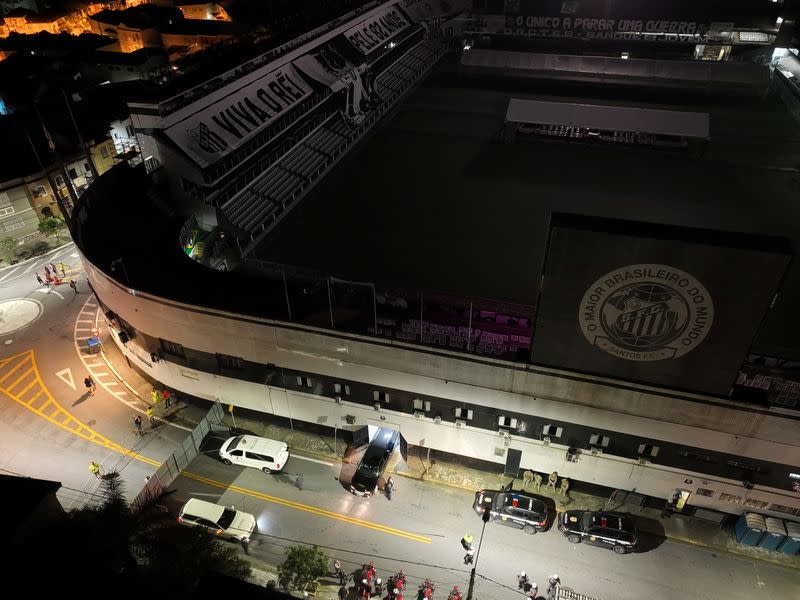 A hearse carrying the body of Brazilian soccer legend Pele arrives at the Vila Belmiro stadium in Santos