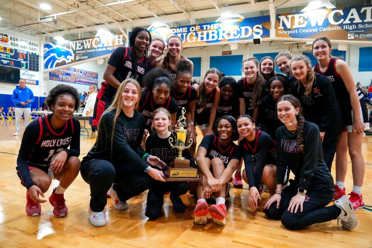 The Holy Cross Indians celebrate with their new trophy after winning the Ninth Region All ‘A’ Classic girls basketball final between the Holy Cross Indians and Newport Central Catholic Thoroughbreds on Saturday, Jan. 6, 2024, at Newport Central Catholic High School in Newport, Ky.