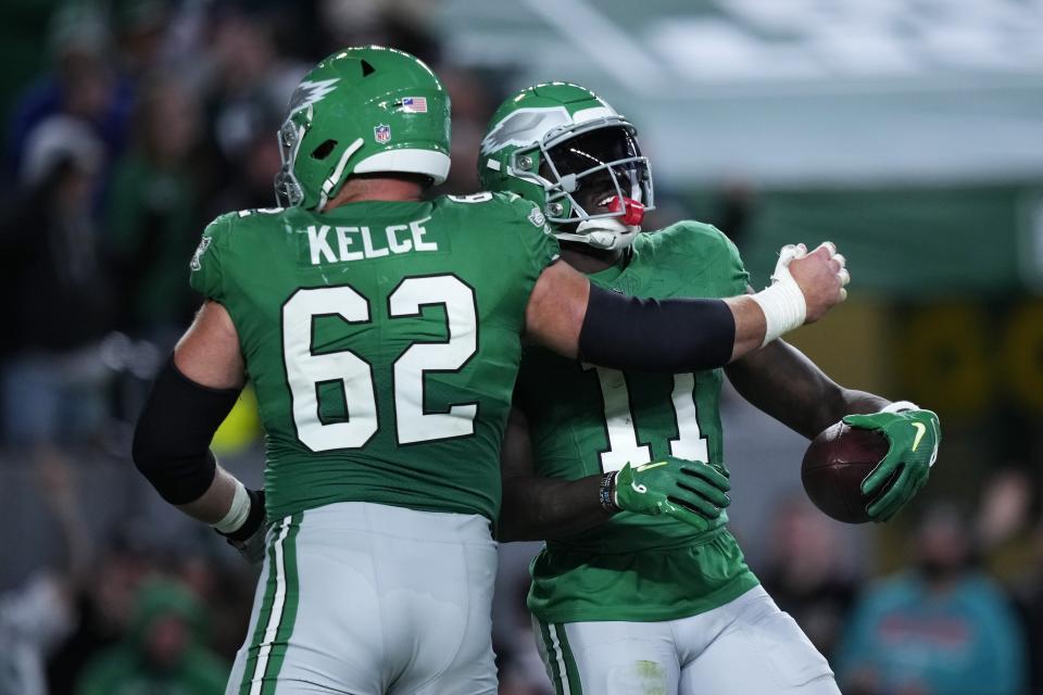 Philadelphia Eagles wide receiver A.J. Brown (11) celebrates a touchdown with Eagles center Jason Kelce (62) during the second half of an NFL football game against the Miami Dolphins on Sunday, Oct. 22, 2023, in Philadelphia. (AP Photo/Matt Slocum)