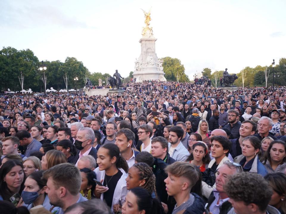 A crowd gathers at Buckingham Palace following Queen Elizabeth II's death.