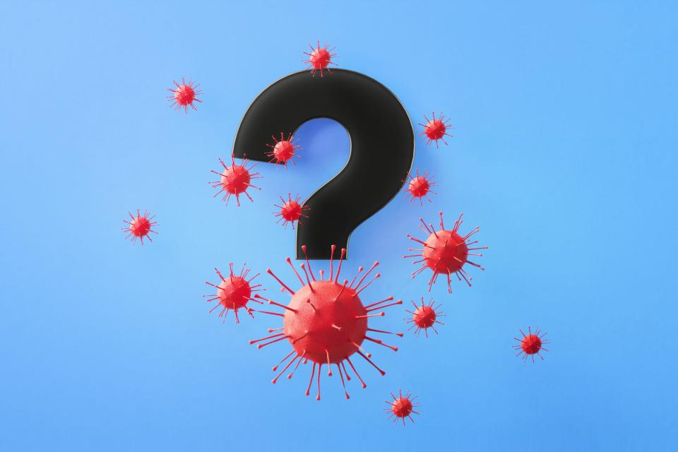 Question mark symbol surrounded by red viruses on blue background, Horizontal composition with copy space. Health and COVID-19 concept.