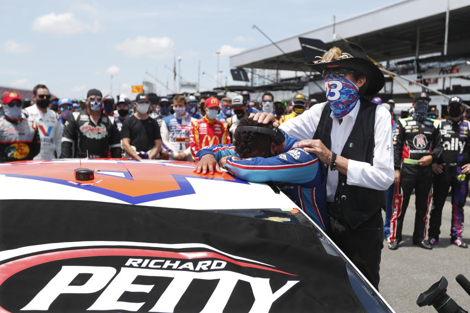 FILE - Driver Bubba Wallace is consoled by team owner Richard Petty prior to the start of a NASCAR Cup Series at the Talladega Superspeedway in Talladega, Ala., Monday, June 22, 2020. On June 21, 2020, NASCAR alerted Wallace a noose had been found in his garage stall at Talladega Superspeedway in Alabama. “RACE: Bubba Wallace," is a Netflix docuseries that chronicles the only Black driver at NASCAR's top level and his professional rise and personal role in social justice issues. (AP Photo/John Bazemore, File)