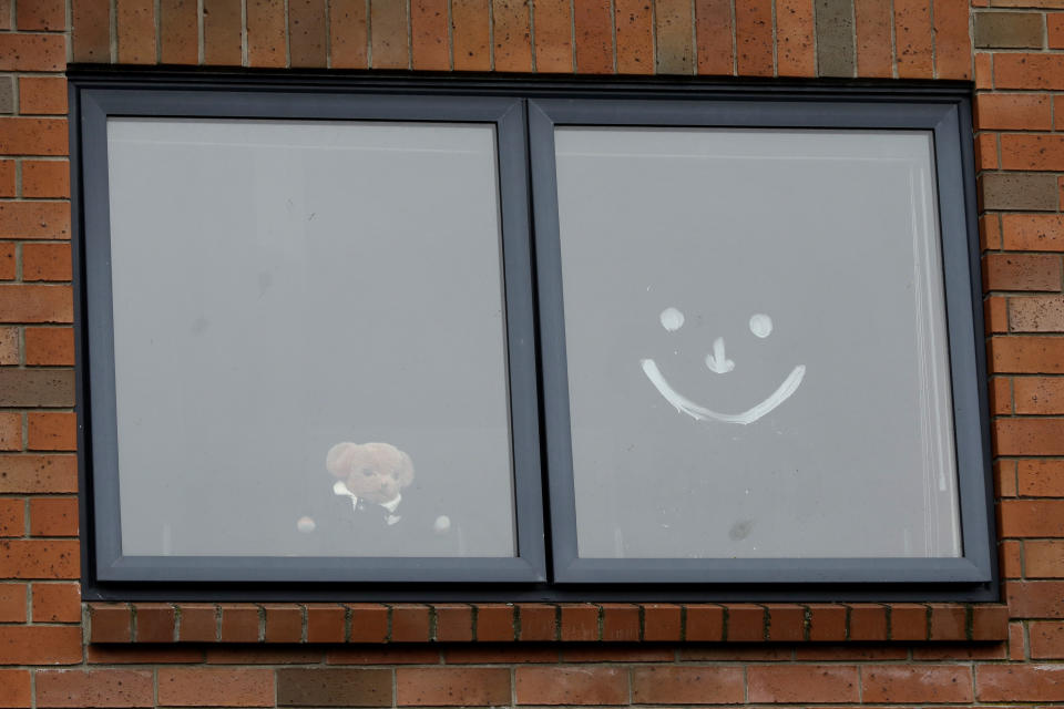 In this Monday, March 30, 2020, photo, a teddy bear sits in a window of a house in Christchurch, New Zealand. New Zealanders are embracing an international movement in which people are placing teddy bears in their windows during coronavirus lockdowns to brighten the mood and give children a game to play by spotting the bears in their neighborhoods. (AP Photo/Mark Baker)