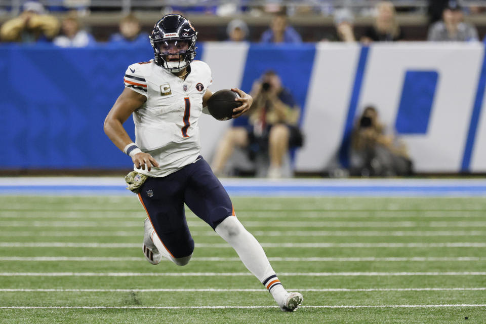 Chicago Bears quarterback Justin Fields (1) scrambles during the second half of an NFL football game against the Detroit Lions, Sunday, Nov. 19, 2023, in Detroit. (AP Photo/Duane Burleson)
