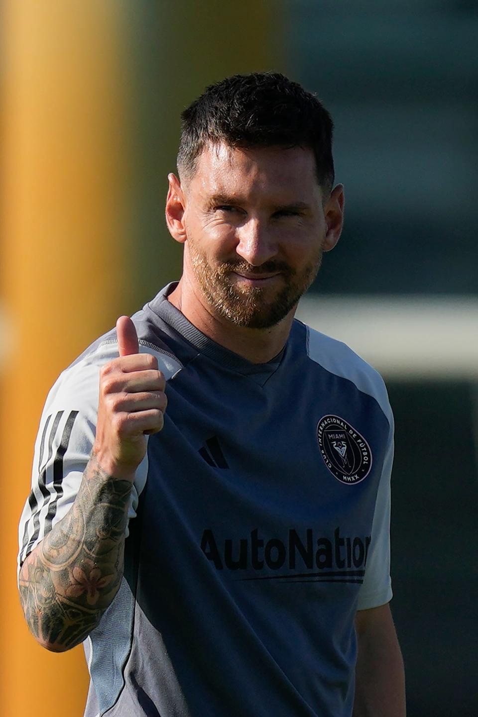 Lionel Messi gives a thumbs up toward journalists on the sideline as he participates in a training session for the Inter Miami MLS soccer team Tuesday, July 18, 2023, in Fort Lauderdale, Fla.