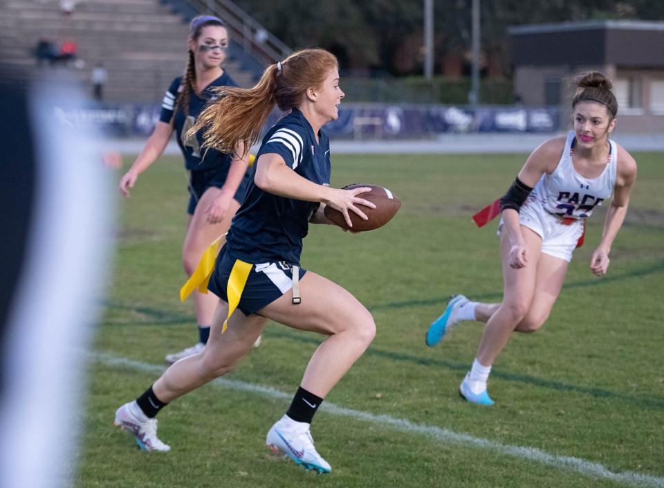 Meredith Pugh (7) carries the ball for a long run on her way to a touchdown to cut the Patriots lead to 19-6 during the Pace vs Gulf Breeze flag football at Gulf Breeze High School on Wednesday, March 22, 2023.