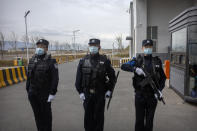 FILE - Police officers stand at the outer entrance of the Urumqi No. 3 Detention Center in Dabancheng in western China's Xinjiang Uyghur Autonomous Region on April 23, 2021. State officials took AP journalists on a tour of a "training center" turned detention site in Dabancheng sprawling over 220 acres and estimated to hold at least 10,000 prisoners - making it by far the largest detention center in China and among the largest on the planet. (AP Photo/Mark Schiefelbein, File)