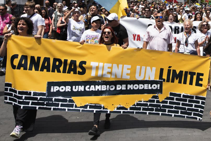 People march during a mass demonstration against tourism which affects the local population with inaccessible housing among other things in Santa Cruz de Tenerife