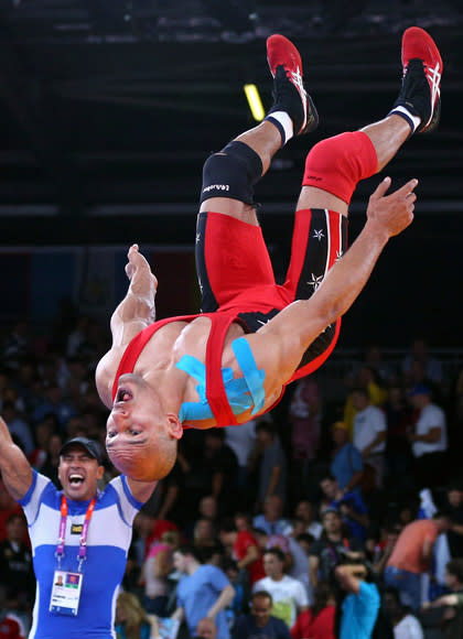 LONDON, ENGLAND - AUGUST 06: Karam Mohamed Gaber Ebrahim of Egypt celebrates winning his Men's Greco-Roman 84 kg Wrestling Semi Final against Damian Janikowski of Poland on Day 10 of the London 2012 Olympic Games at ExCeL on August 6, 2012 in London, England. (Photo by Cameron Spencer/Getty Images)