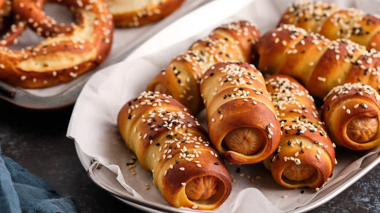 Pretzel pigs in blankets with sesame seeds