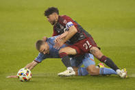 Toronto FC midfielder Jonathan Osorio (21) forces New York City FC midfielder James Sands (6) to the turf during the first half of an MLS soccer match Saturday, May 11, 2024, in Toronto. (Frank Gunn/The Canadian Press via AP)