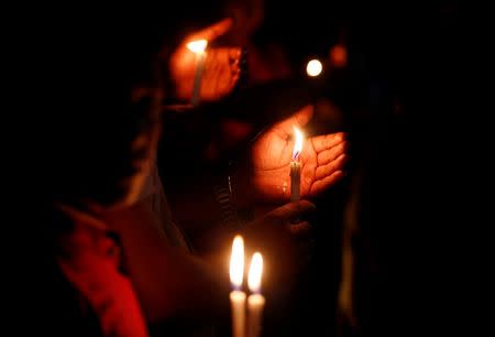 People attend a candle light vigil for the victims of the attack on the Holey Artisan Bakery and the O'Kitchen Restaurant, in Dhaka, Bangladesh, July 3, 2016. REUTERS/Adnan Abidi