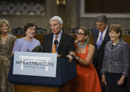 The bipartisan group of Senate negotiators speak to reporters just after a vote to start work on a nearly $1 trillion bipartisan infrastructure package, at the Capitol in Washington, Wednesday, July 28, 2021. From left are Sen. Lisa Murkowski, R-Alaska, Sen. Susan Collins, R-Maine, Sen. Rob Portman, R-Ohio, Sen. Kyrsten Sinema, D-Ariz., Sen. Joe Manchin, D-W.Va., and Sen. Jeanne Shaheen, D-N.H., (AP Photo/J. Scott Applewhite)