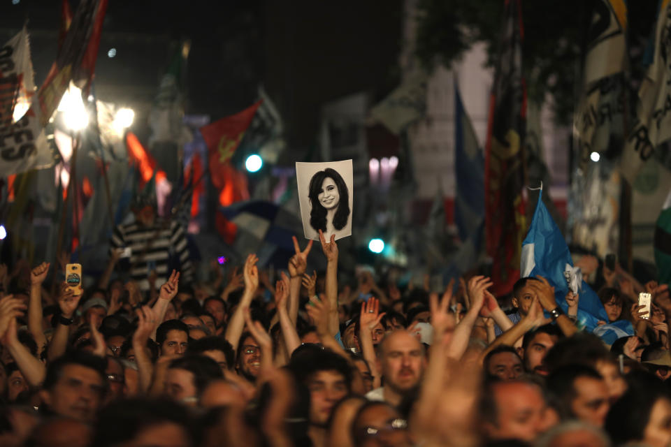 Supporters of Peronist presidential candidate Alberto Fernández and running mate, former President Cristina Fernández, hold up Cristina's image after incumbent President Mauricio Macri conceded defeat at the end of election day in Buenos Aires, Argentina, Sunday, Oct. 27, 2019. (AP Photo/Natacha Pisarenko)