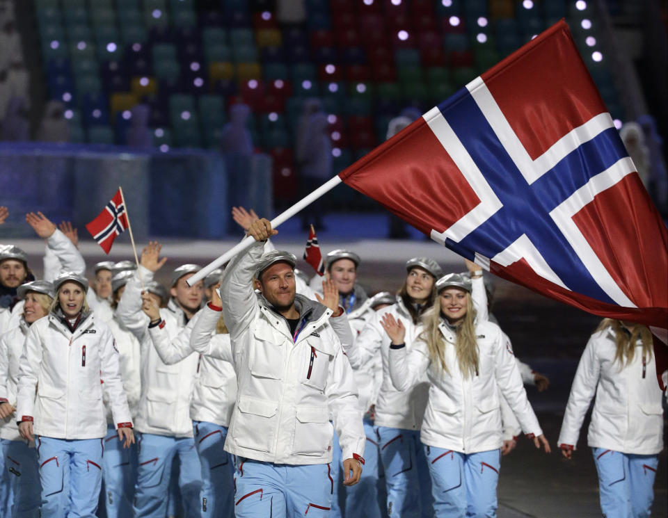 Aksel Lund Svindal of Norway carries the national flag as he leads the team during the opening ceremony of the 2014 Winter Olympics in Sochi, Russia, Friday, Feb. 7, 2014. (AP Photo/Mark Humphrey)