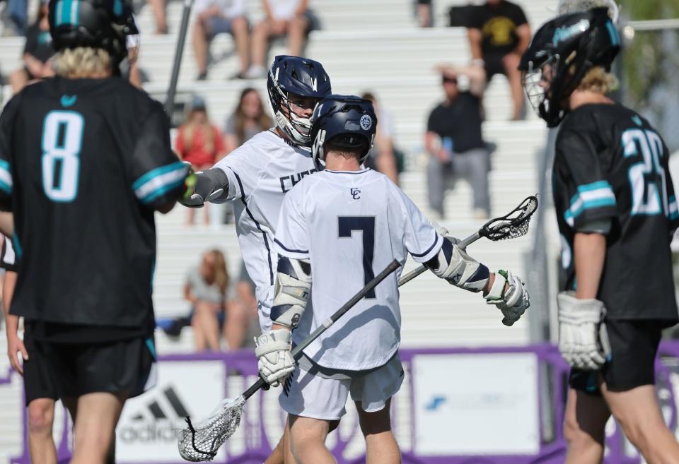 Corner Canyon’s Porter Wells (4) celebrates his goal with Dawsen Andersen (7) against Farmington in the 6A boys lacrosse state semifinal in Salt Lake City on Wednesday, May 24, 2023. Corner Canyon won 12-0. | Jeffrey D. Allred, Deseret News