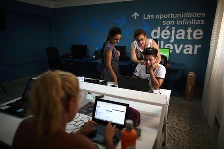 People work at the media platform OnCuba office in Havana, Cuba, August 2, 2016. REUTERS/Alexandre Meneghini/Files