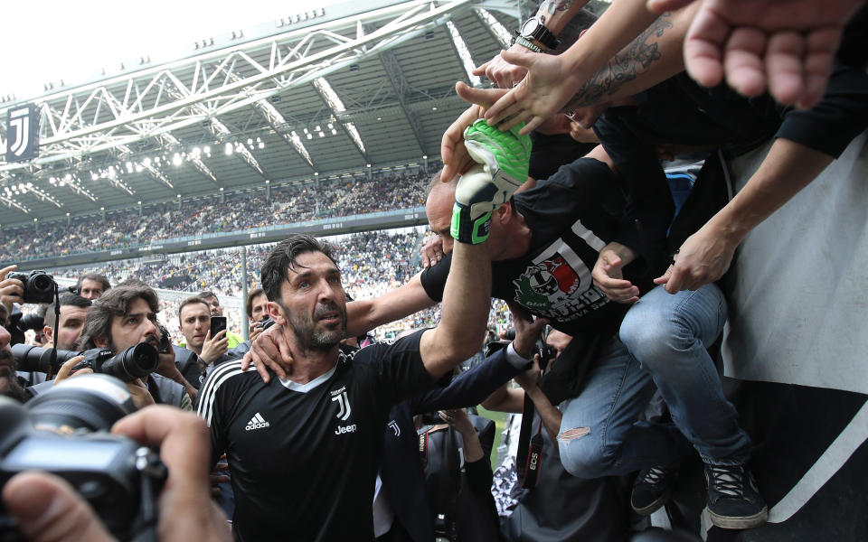 Gianluigi Buffon is greeted by fans with hugs and a banner before his final game at Juventus. (Getty)