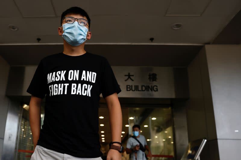 Pro-democracy activist Joshua Wong arrives at the Eastern Magistrates' Courts over illegal assembly and violation of an emergency law banning face coverings last year, in Hong Kong