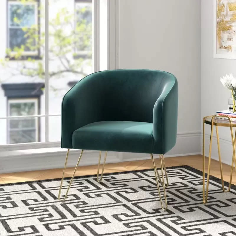 <div><p>"Think beyond the desk," Gage said. "I love incorporating other functional setups for laptop work – like a rattan daybed or a velvet armchair."This eye-catching accent chair is elevated but inviting and comes in dark green and blue. </p><p><i>You can buy the <a href="https://www.tkqlhce.com/click-8953967-13720150?sid=seasonal-depression-hom-eoffice-fjollaarifi-03-14-2023-7357644&url=https%3A%2F%2Fwww.wayfair.com%2Ffurniture%2Fpdp%2Fwilla-arlo-interiors-grimsley-265-wide-velvet-barrel-chair-w000795050.html" rel="nofollow noopener" target="_blank" data-ylk="slk:Grimsley Upholstered Barrel Chair;elm:context_link;itc:0;sec:content-canvas" class="link ">Grimsley Upholstered Barrel Chair</a> from Wayfair for around $138. </i></p></div><span> Wayfair</span>