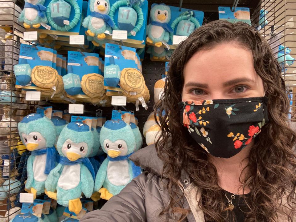 A selfie of a woman taken in front of Petco's Hanukkah toy display.